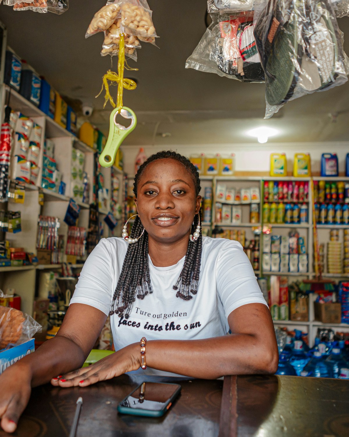 African retail owner working at the counter of her shop